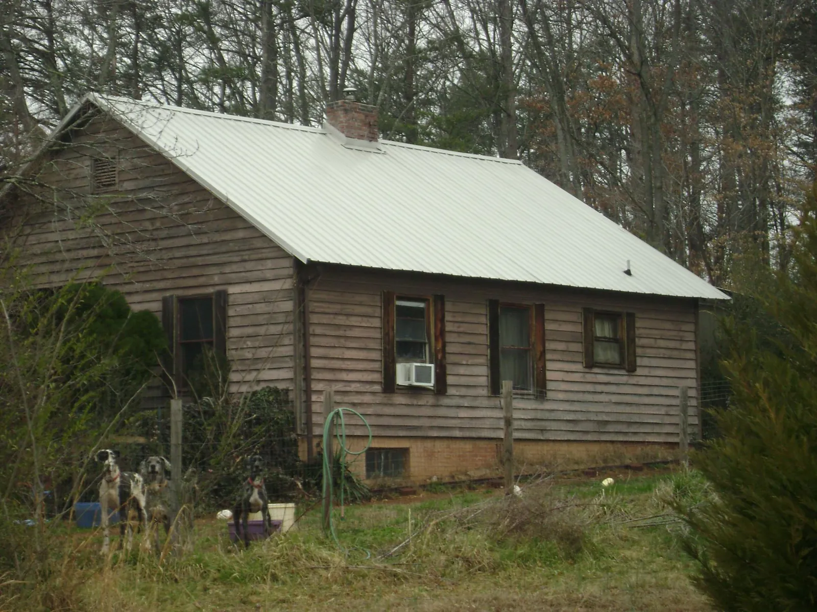 White metal roof on an old wood sided farmhouse, from a Metal Roof Installation job in Maurice